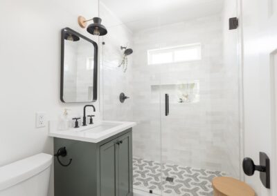 ADU Bathroom Gray Vanity Black Fixtures Tiled Shower 1