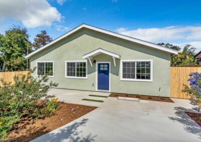 Snap-ADU-3-Car-Garage-Carlsbad-Basswood-2BR1BA-1000sqft-Exterior-Front-Angle-Blue-Front-Door-Covered-Entry-Stucco-Window-Grids