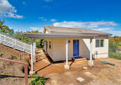 Snap-ADU-Escondido-Cody-Lane-2BR1BA-750-sqft-Exterior-Stairs-White-Rail-Covered-Porch-Blue-Front-Door