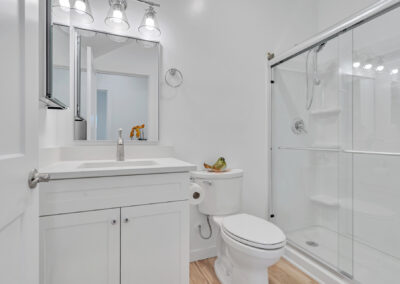 Snap-ADU-Oceanside-South-Ditmar-2-bedroom-2-bathroom-1000-sqft-two-story-Interior-Shot-Secondary-Bathroom-Downstairs-White-Vanity-Glass-Shower