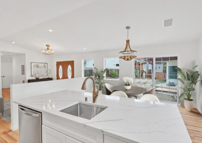 Snap-ADU-Rancho-Penasquitos-Palm-Beach-Ln-2-BR-2-BA-1200-sqft-Interior-Kitchen-Island-to-Living-Space-and-Backyard-View-STAGED